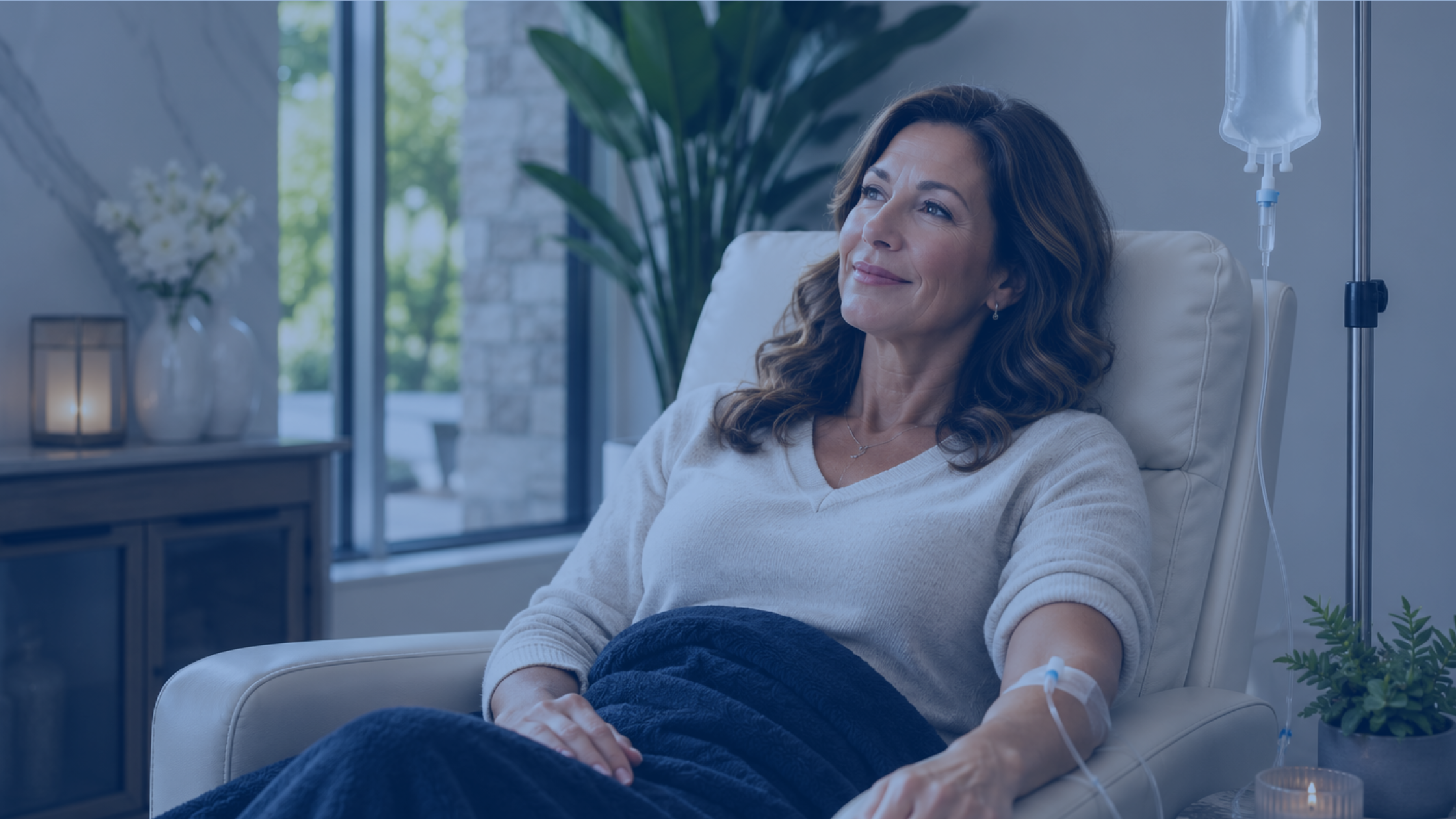 A woman relaxing in a lounge chair while receiving a Myers' Cocktail IV drip at Prime IV
